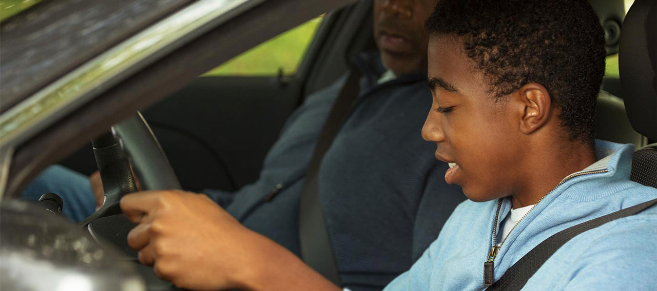 father teaching his son how to drive
