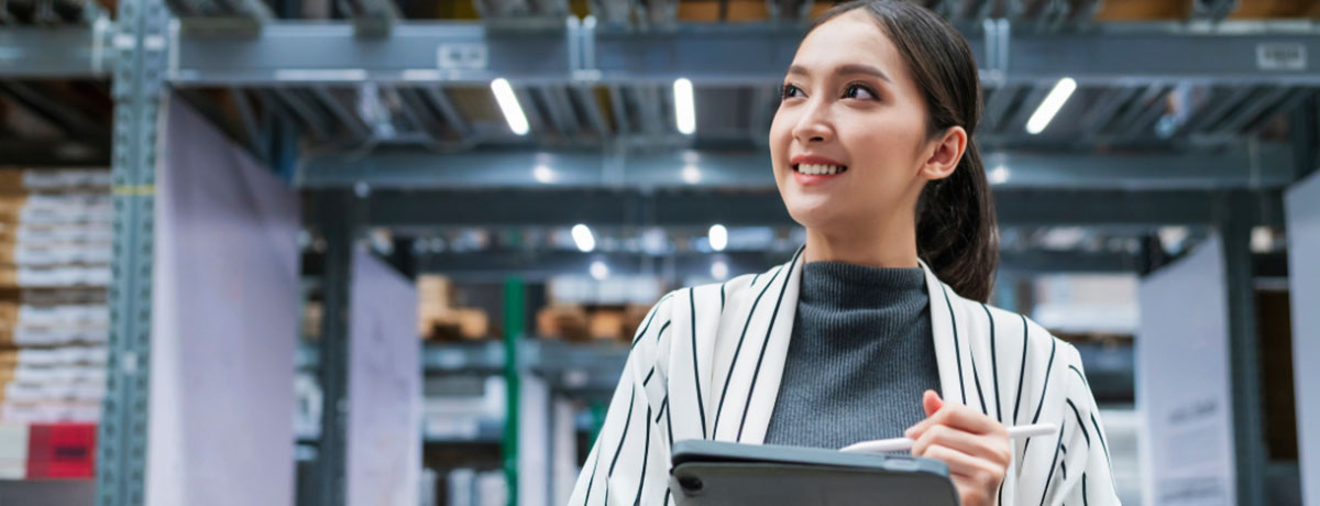 young woman sitting on colorful wall