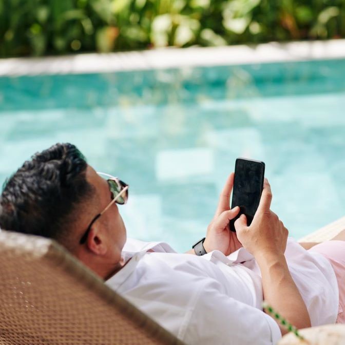 Man on phone by pool