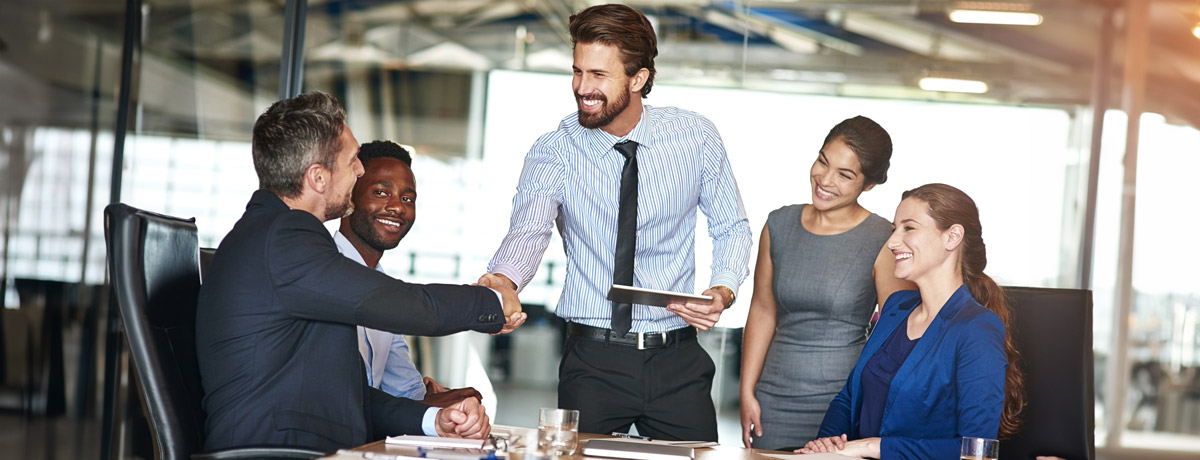 business people shaking hands in conference room